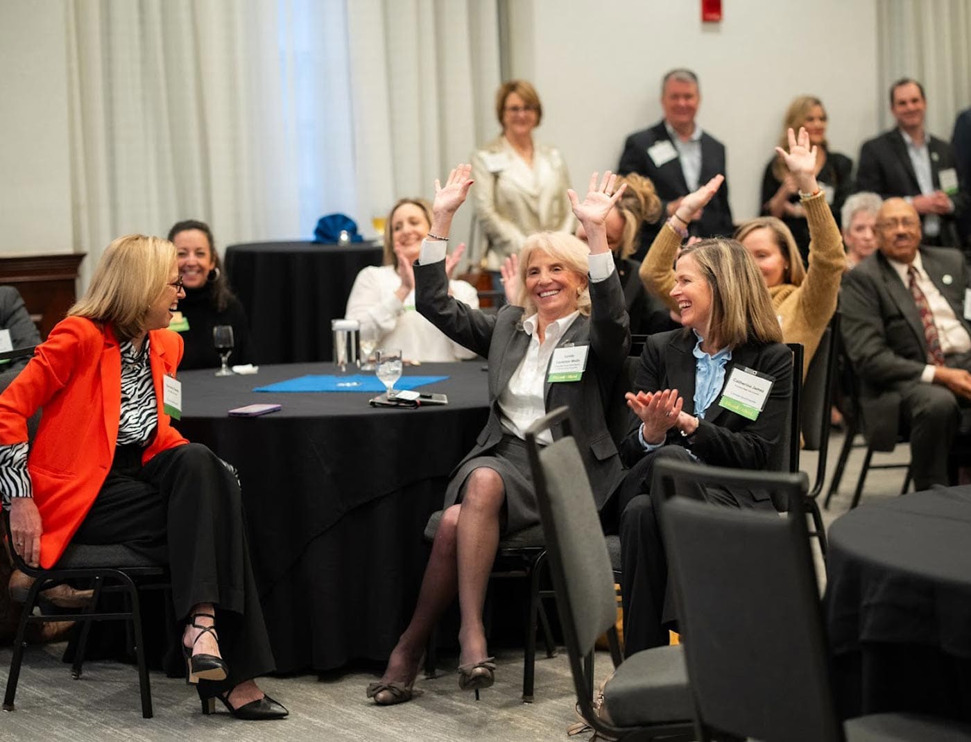 Attendees cheering and applauding at a Greater Good Greenville event